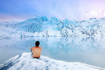 photo of shirtless man looking at glaciers