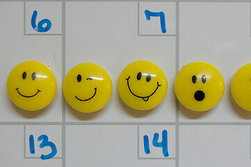 emoticon push pins on dry erase board