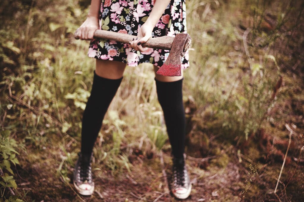 photo of female holding axe