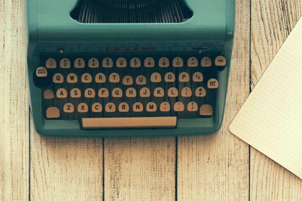 photo of green typewriter on a table