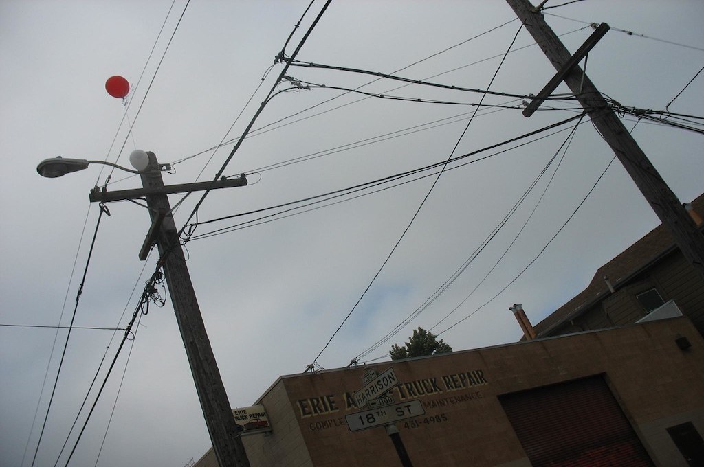 photo of balloons stuck in overhead electrical wire