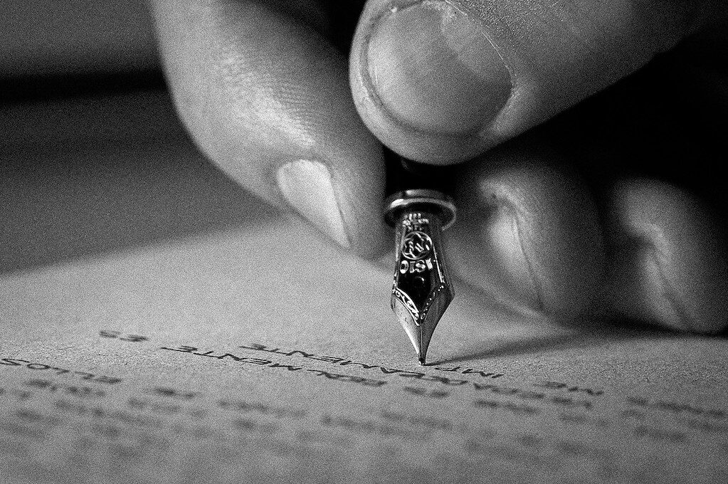 photo of hand writing with fancy pen