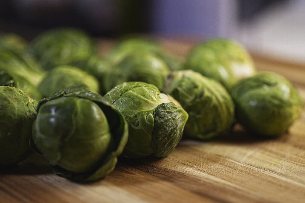 photo of Brussels sprouts on wooden surface