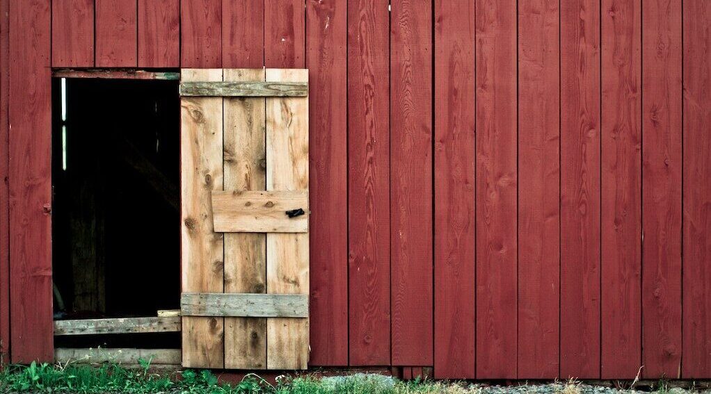 photo of red wooden wall during daytime